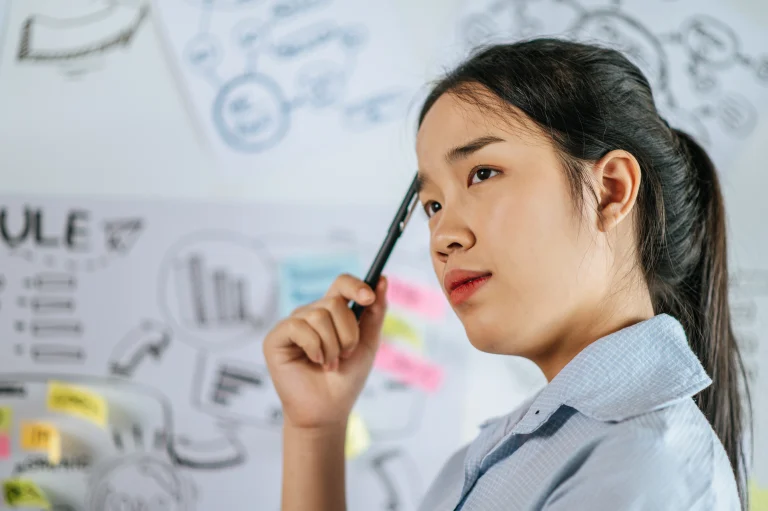 A thoughtful woman reflecting, symbolizing the concept of growth mindset and self-awareness.